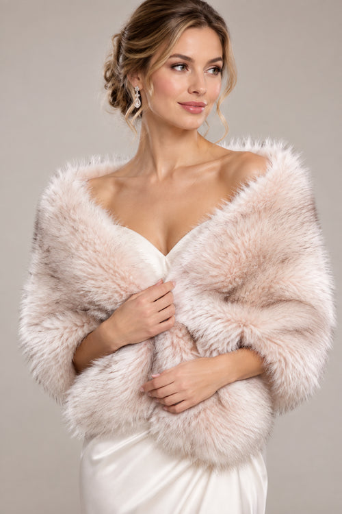 A light beige and cream faux fur wrap or shrug draped on a white mannequin torso, set against a blurred outdoor garden background.